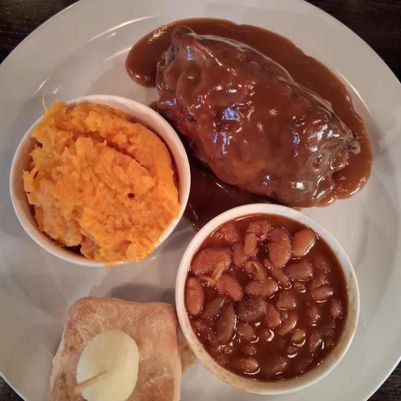 Annie O's Kitchen's southern meal with meatloaf, mashed sweet potatoes, baked beans, and cornbread.
